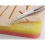 Almohadilla de práctica de sutura con malla